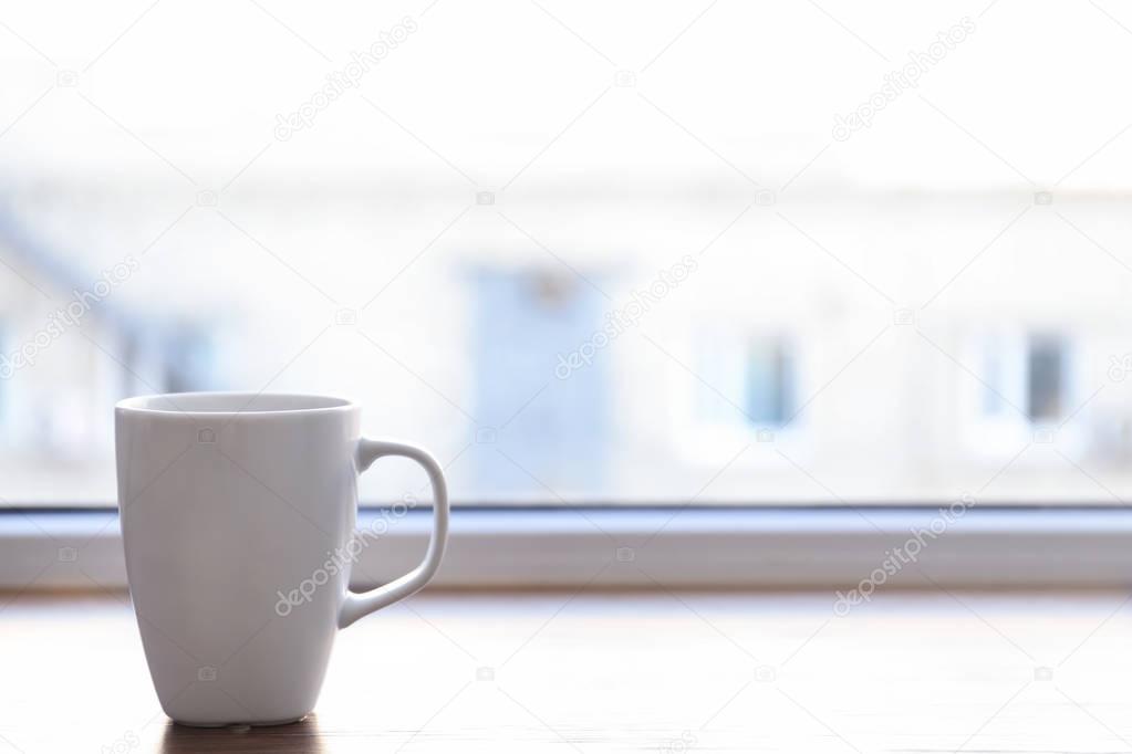 Ceramic cup on window sill