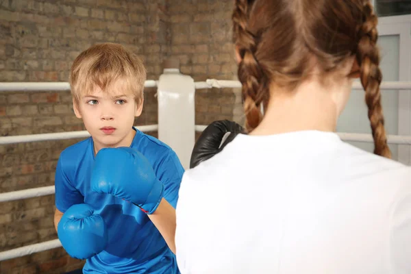 Little boy and girl fighting on boxing ring — Stock Photo, Image