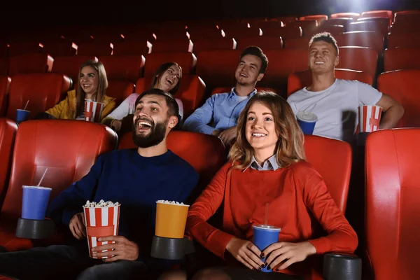 Young people watching movie in cinema