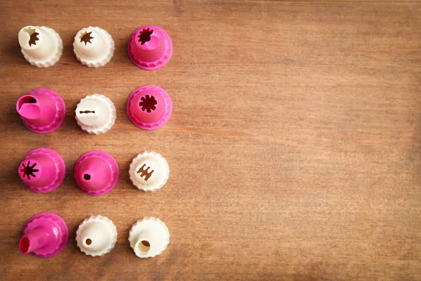 Kitchen utensils for pastries on wooden background