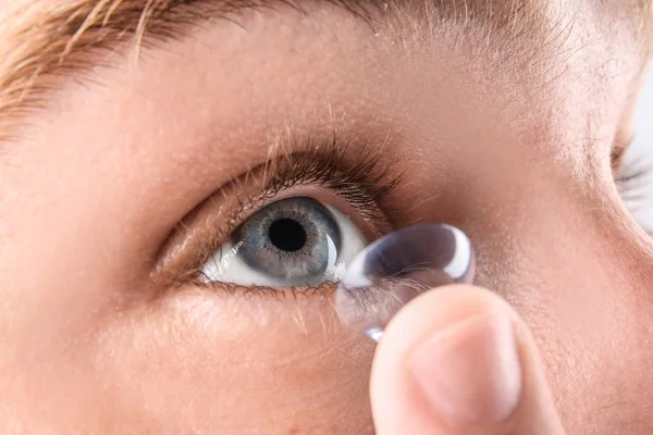 Jovem colocando lente de contato em seu olho, close-up — Fotografia de Stock