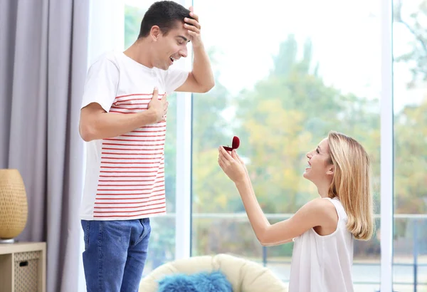 Woman with engagement ring making proposal of marriage to man at home — Stock Photo, Image