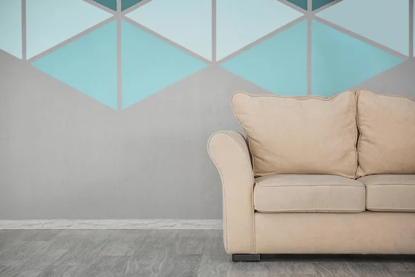 Cozy sofa near colorful wall