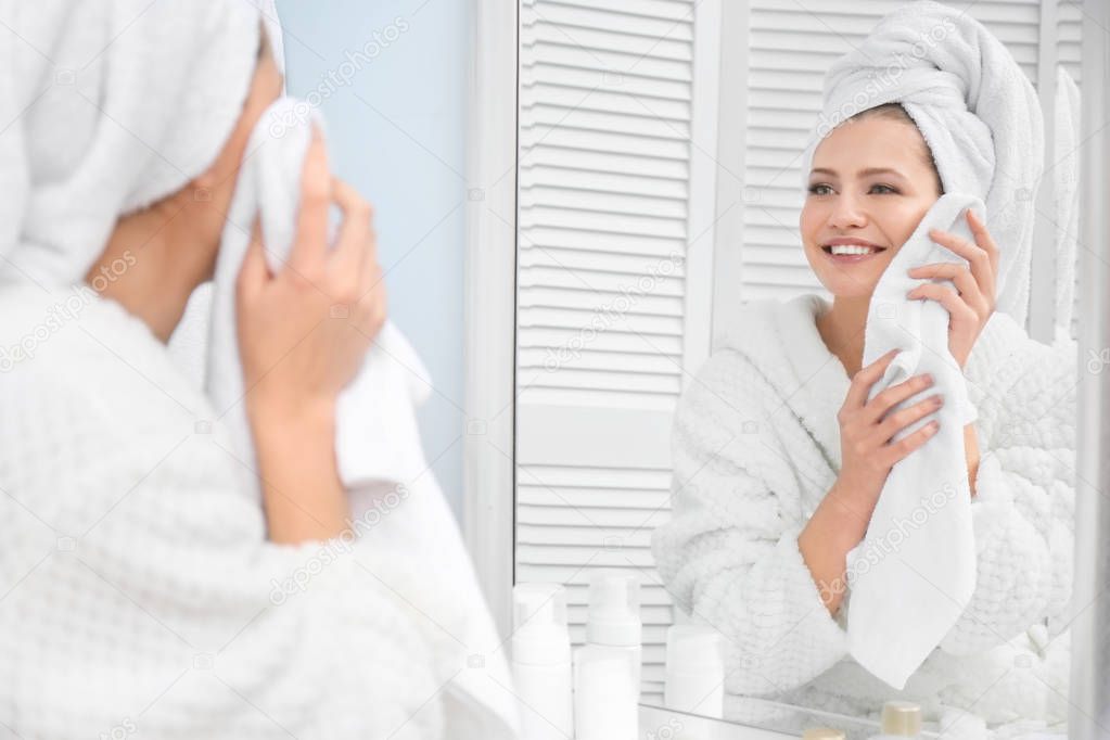 woman wiping face with towel