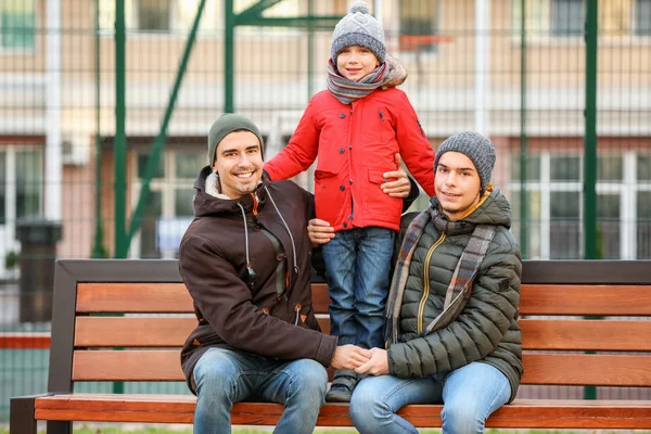 Male Gay Couple Adopted Boy Sitting Bench Park — Stock Photo, Image