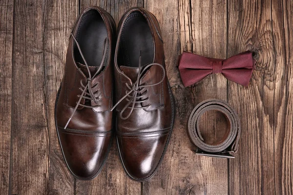 Composition with elegant leather men\'s shoes on wooden background