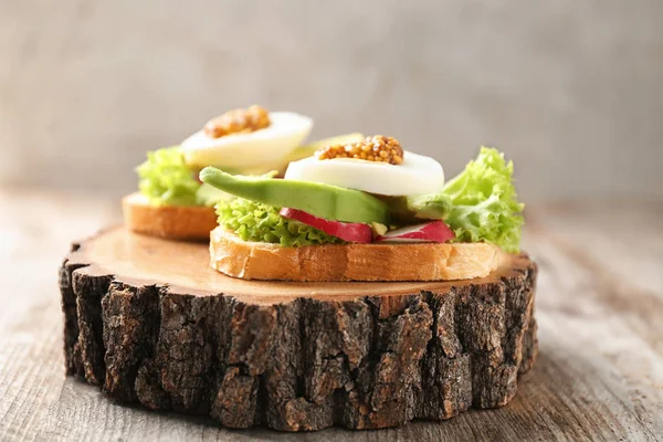 Delicious sandwich on wooden board — Stock Photo, Image