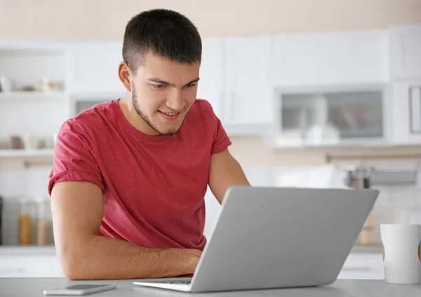 Young man using laptop — Stock Photo, Image