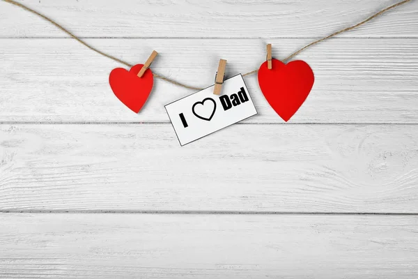 Composition with phrase I LOVE DAD for Father\'s Day on wooden background