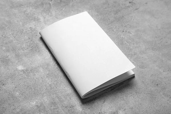 Blank booklet on grey background. Mock up for design