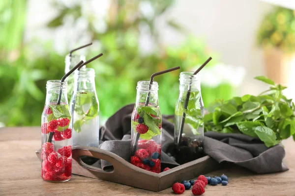 Bottles Infused Water Berries Wooden Table — Stock Photo, Image