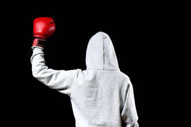 Boxer in hoodie posing on black background clipart