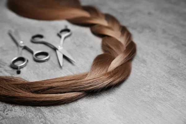 Professional Hairdresser Scissors Brown Braid Grey Background — Stock Photo, Image