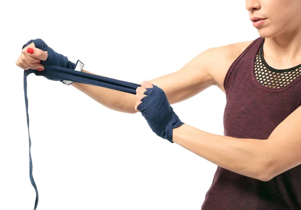 Boxer woman applying wrist wraps on white background