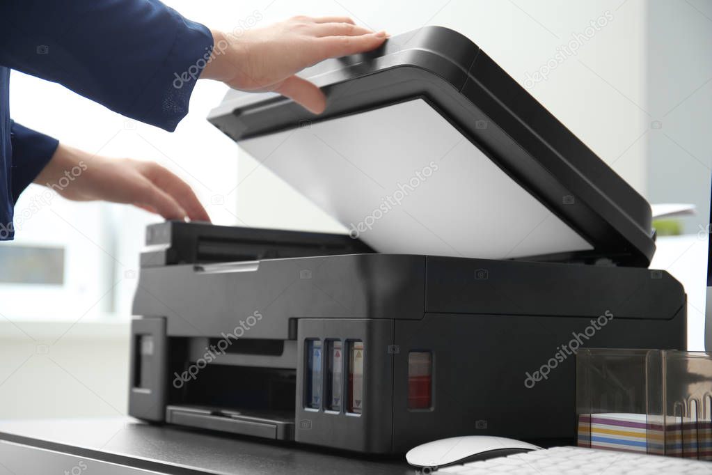 Woman making copy of document in office, closeup