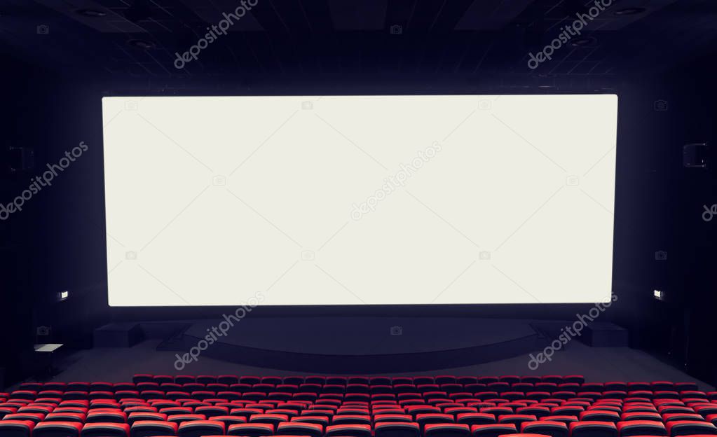 Empty cinema with large screen and comfortable chairs