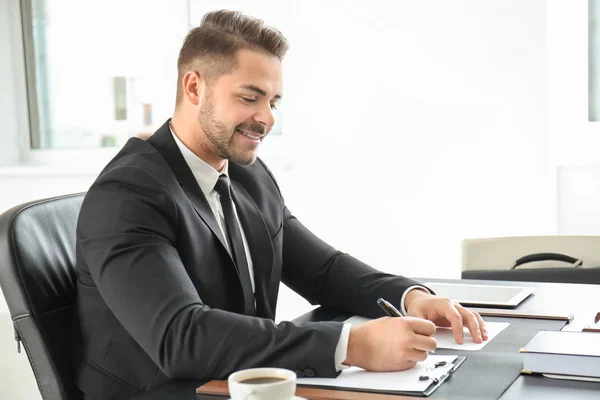 Handsome young lawyer in office