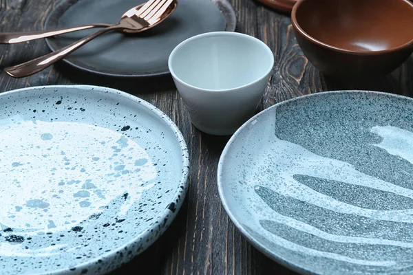 Ceramic tableware on wooden background