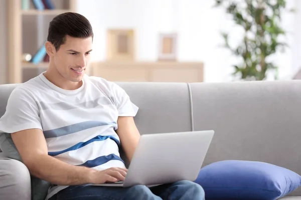 Young Man Using Laptop Couch Indoors — Stock Photo, Image