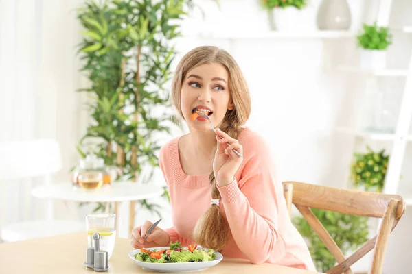 若いです美しいです女性食べる新鮮なサラダに家 — ストック写真