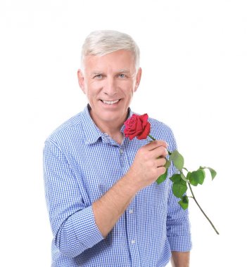 Beyaz zemin üzerine kırmızı gül ile çekici olgun adam