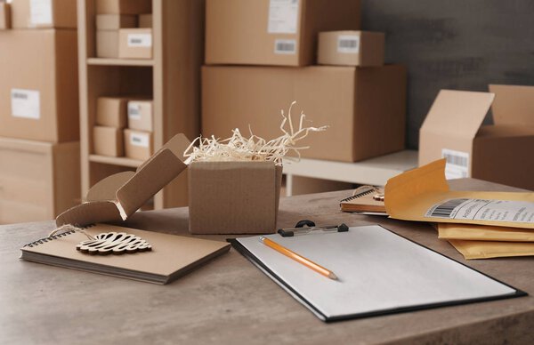 Подготовка посылок к отправке заказчику на столе
