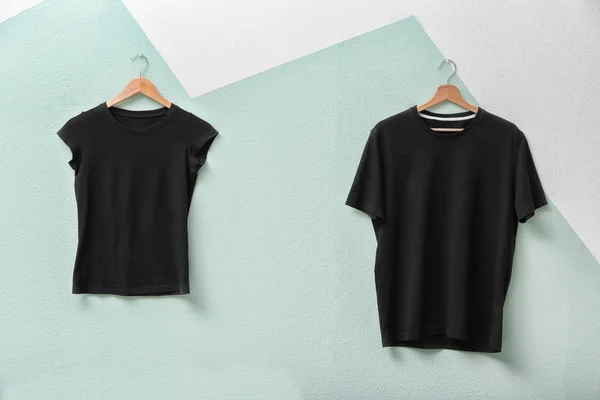Black t-shirts on color background. Mockup for design