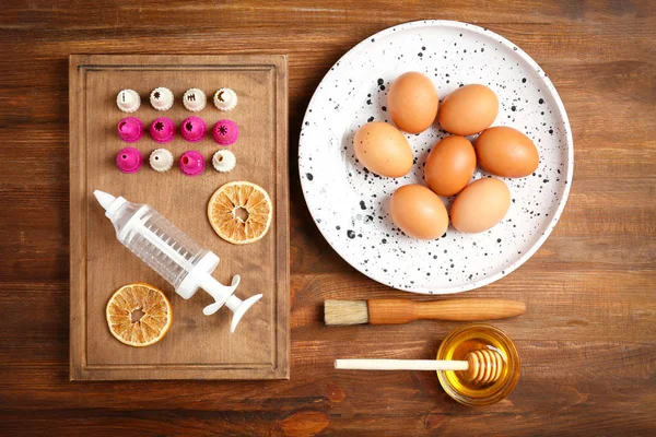 Kitchen utensils and ingredients for pastries on wooden background