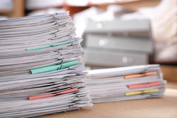 Stack of old paper documents on table in archive, closeup