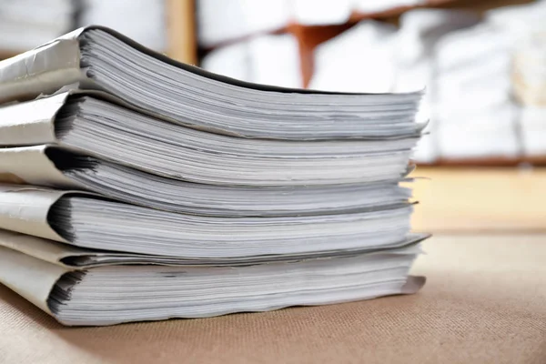 Stack of cardboard folders with documents in archive, closeup