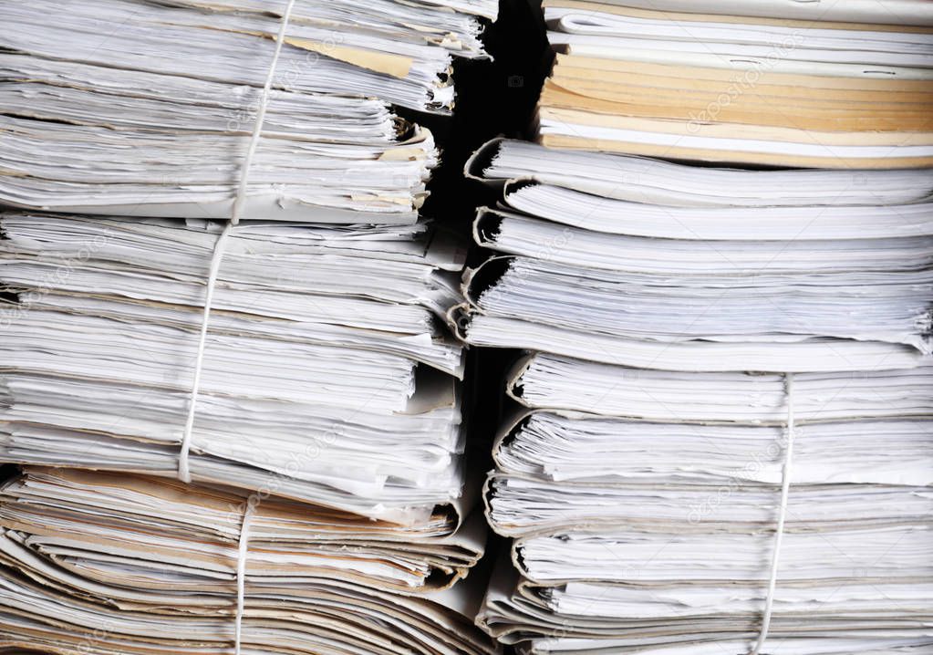 Stacks of old folders with documents in archive, closeup