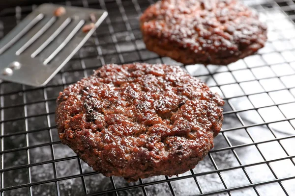 Burger patty on grill, closeup