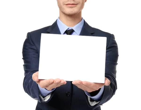 Empresario con hoja de papel en blanco para publicidad sobre fondo blanco, primer plano — Foto de Stock