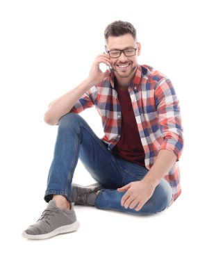 Beyaz arka plan üzerinde cep telefonu konuşurken çekici genç adam