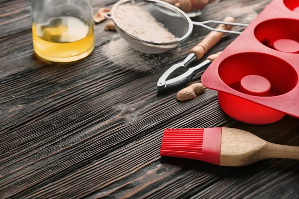 Kitchen utensils and ingredients for pastries on wooden surface