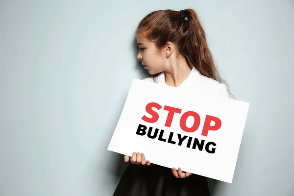 Little Girl Holding Sign Text Stop Bullying Light Background — Stock Photo, Image