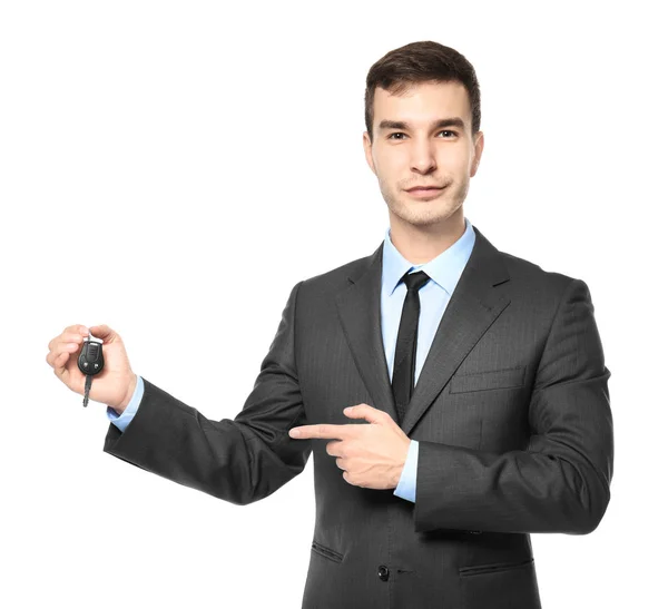 Handsome car salesman with key on white background — Stock Photo, Image