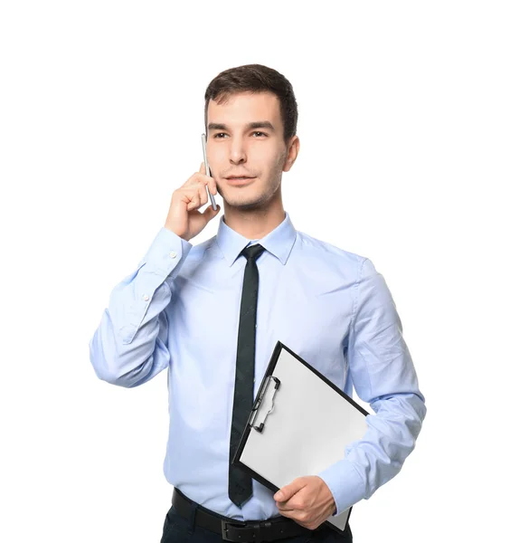 Handsome car salesman talking on mobile phone against white background — Stock Photo, Image