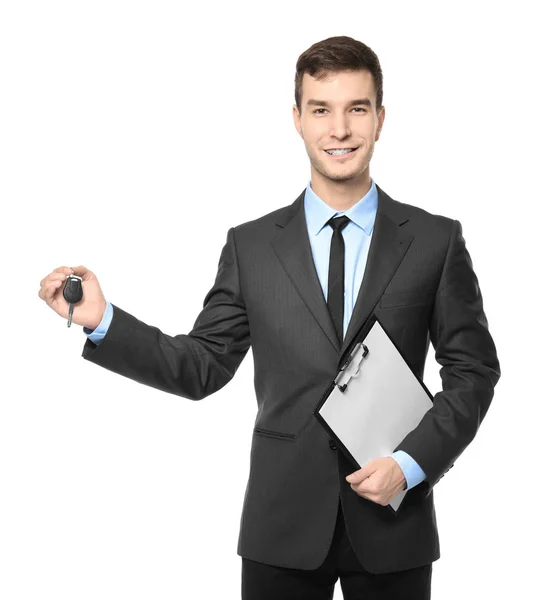 Handsome car salesman with key and clipboard on white background — Stock Photo, Image