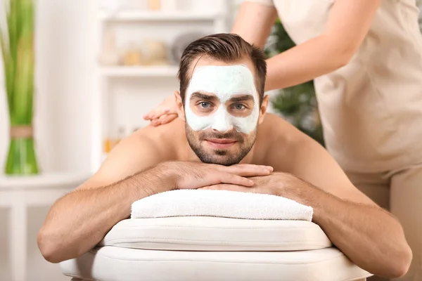 Young man having massage in spa salon — Stock Photo, Image