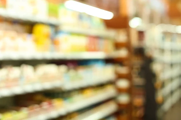 Variedad de diferentes alimentos para bebés en el supermercado, vista borrosa —  Fotos de Stock