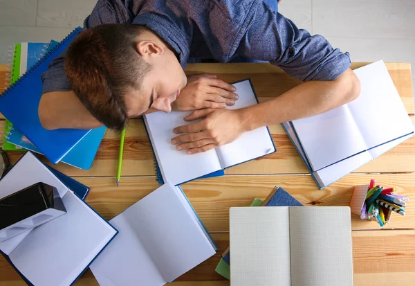Estudiante cansado durmiendo en su escritorio. Preparación para el examen —  Fotos de Stock