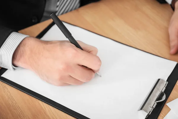 Man writing on sheet of paper, closeup — Stock Photo, Image