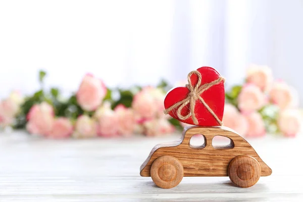 Decorative wooden car with heart figure on table — Stock Photo, Image