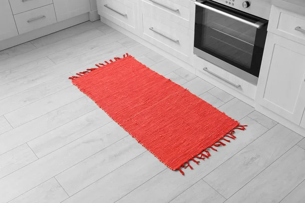 Colorful rug on floor in kitchen