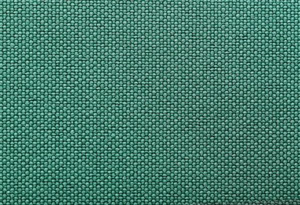 Green cotton fabric texture as background, closeup