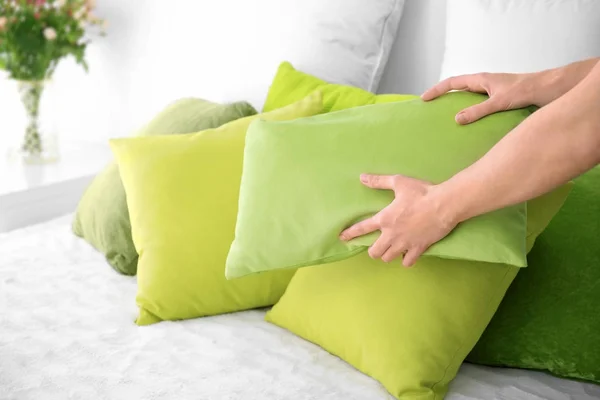 Woman putting pillow on bed, closeup — Stock Photo, Image