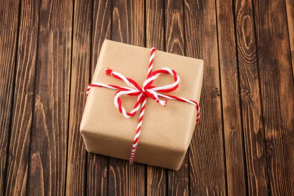 Parcel gift box on wooden background — Stock Photo, Image