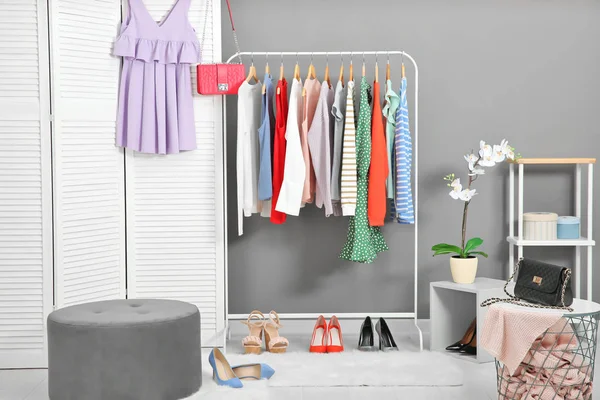 Rack with collection of clothes in dressing room — Stock Photo, Image