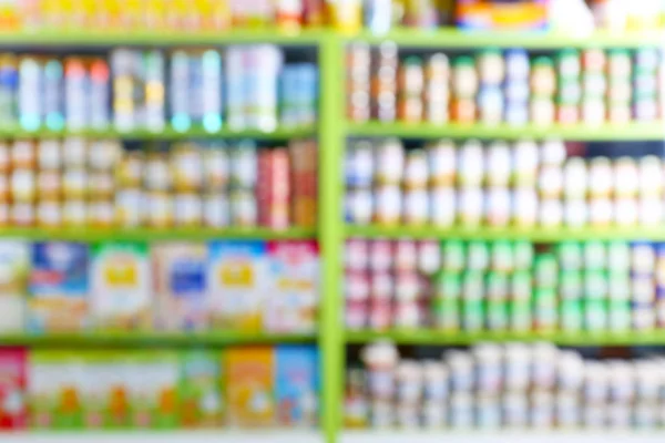 Blurred view of shelves with baby food in shop — Stock Photo, Image